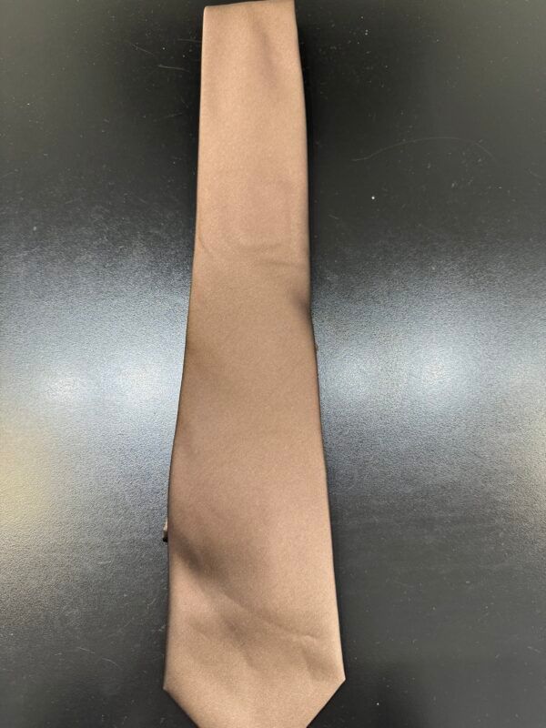 A brown tie is sitting on a black table.