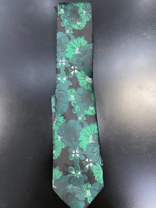 A black tie with green flowers on it