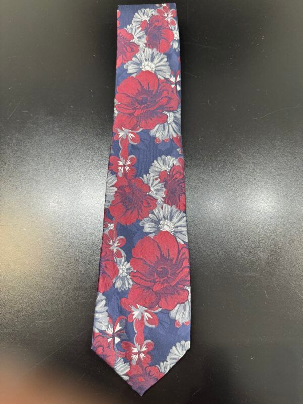 A blue and red tie with flowers on it