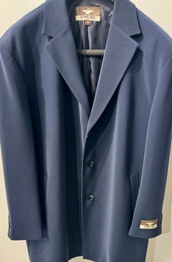 A blue suit jacket is hanging on a hanger
