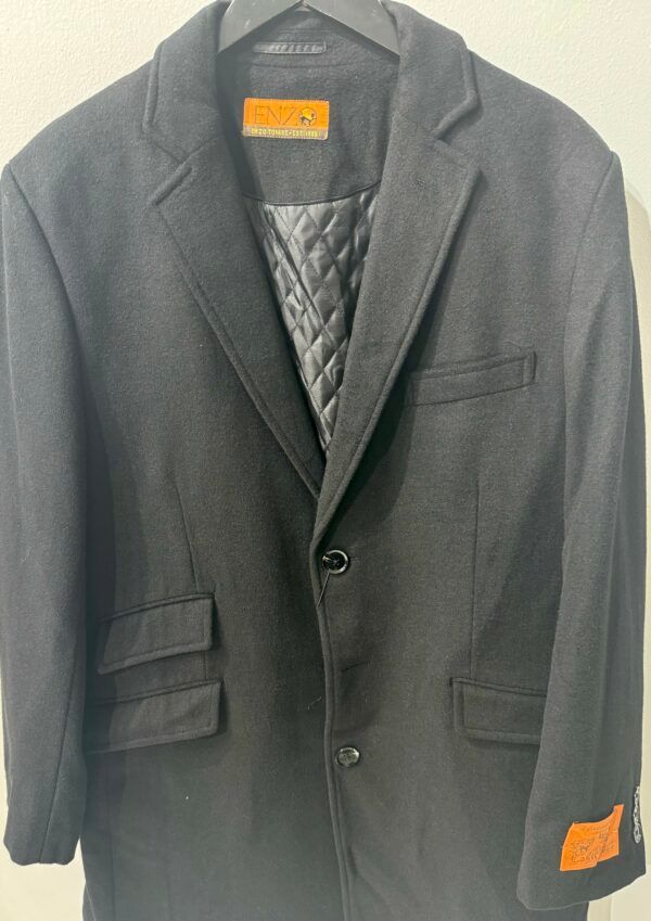 A black jacket with a quilted lining is hanging on a hanger.