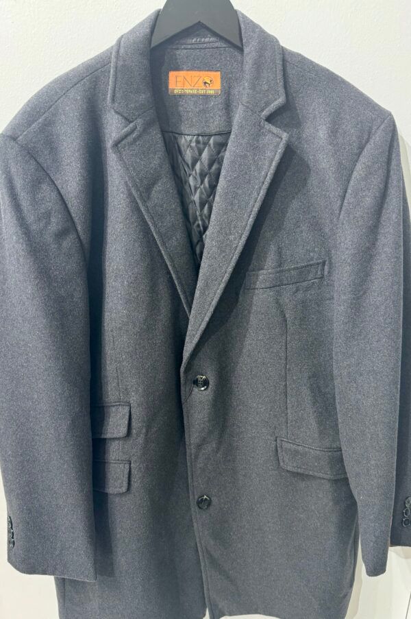A grey jacket with a quilted lining is hanging on a hanger.