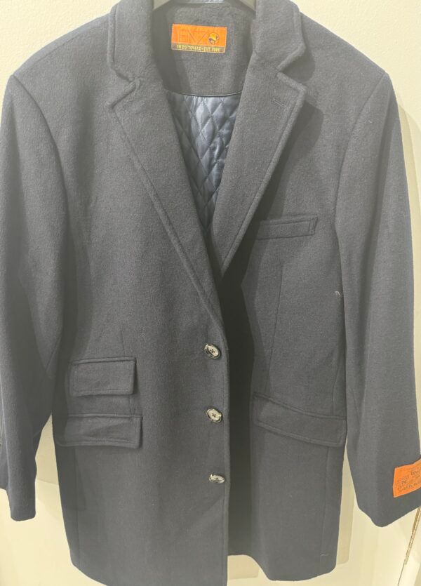 A black jacket with a blue lining is hanging on a hanger.
