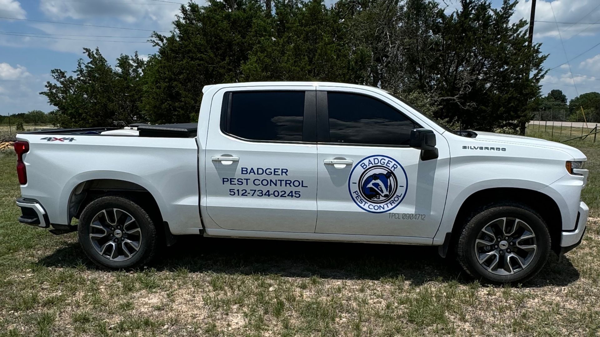 White Badger Pest Control truck parked outdoors.