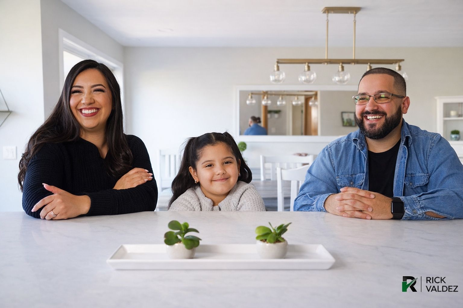 Family smiles in a bright kitchen, seated at a white countertop