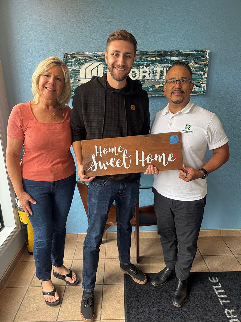 Three people holding a 