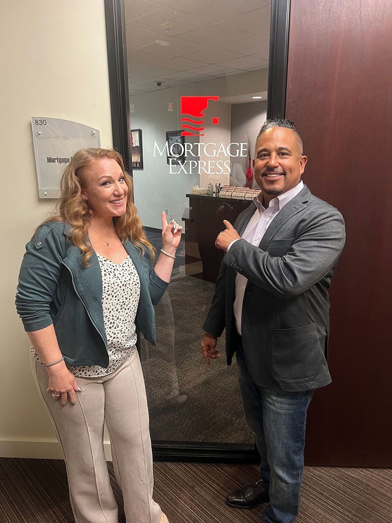 Woman and man pointing at a door with 