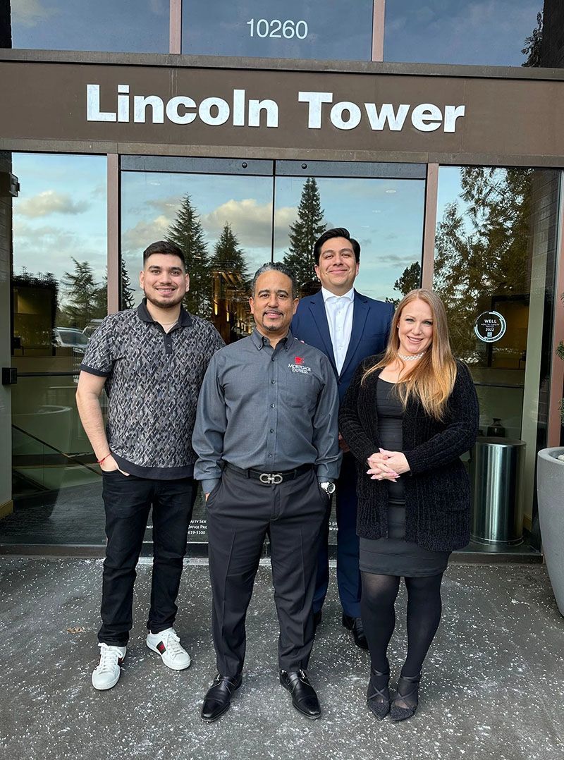 Four people stand in front of 