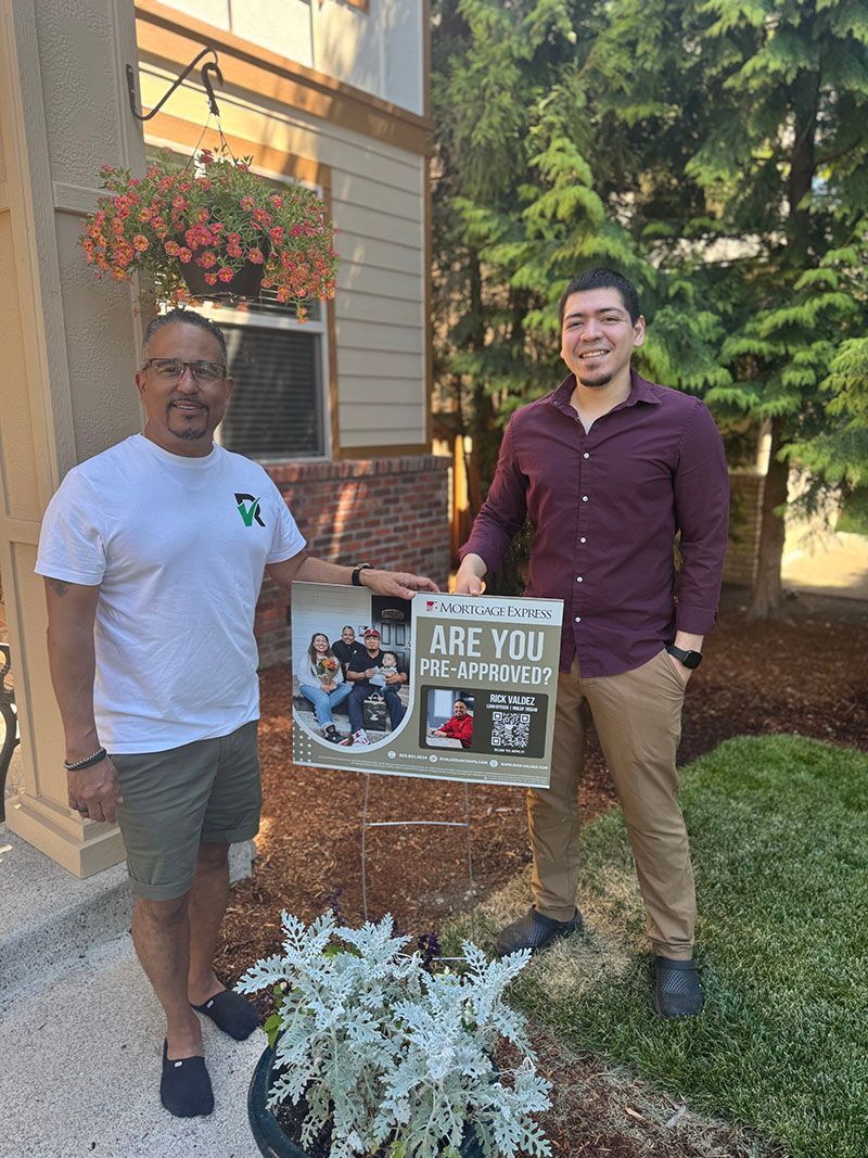 Two men holding a poster that says 