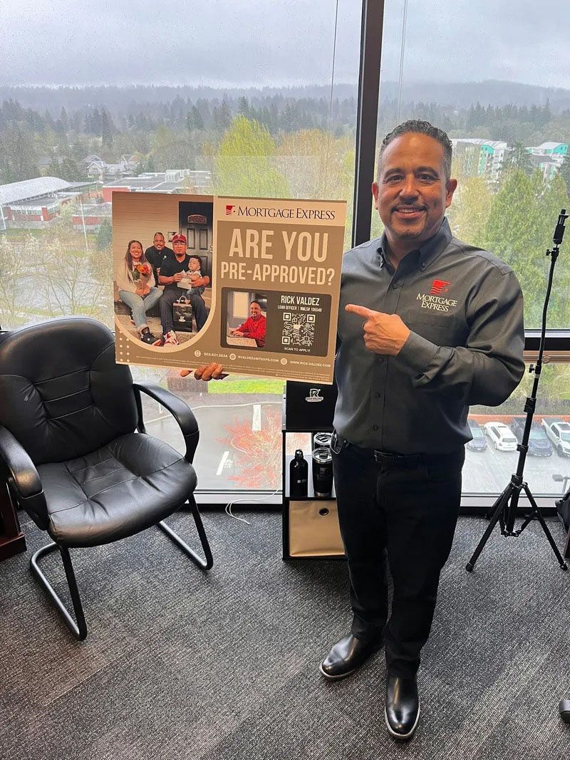 Man in gray shirt points to sign: 