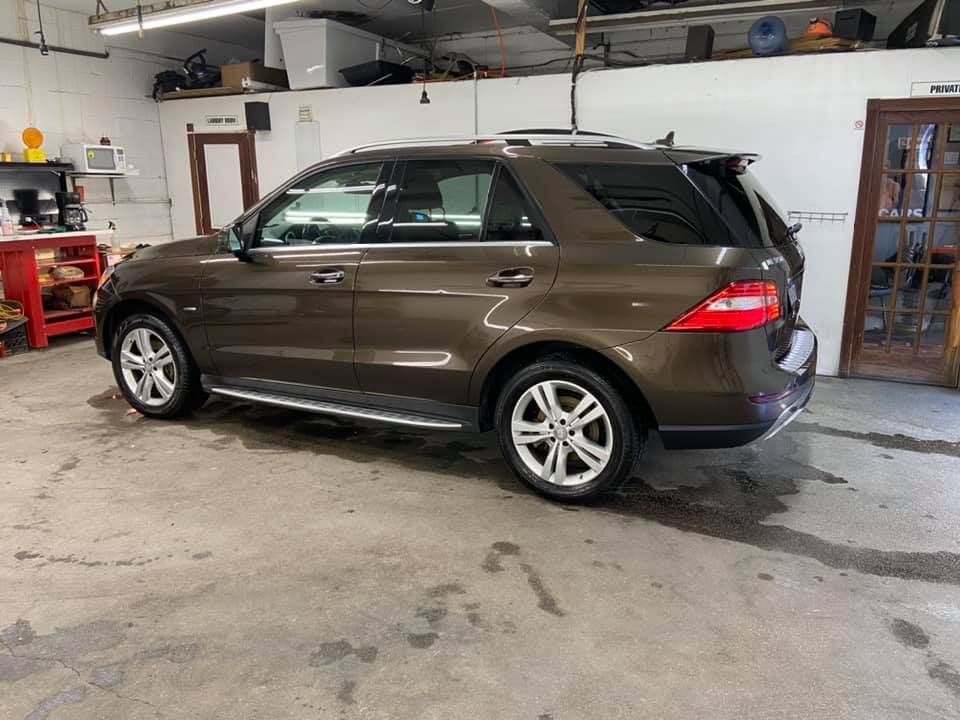 Brown SUV in a garage with a concrete floor.