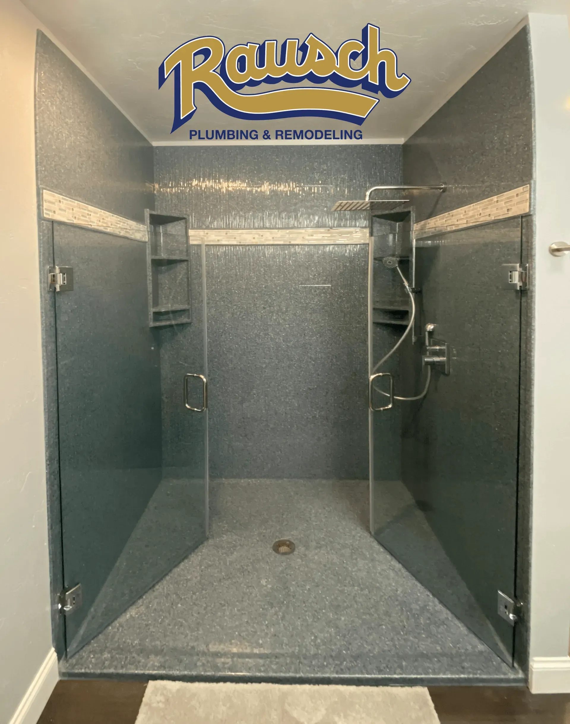 Shower enclosure with gray, textured tile, glass doors, and Raush Plumbing logo.