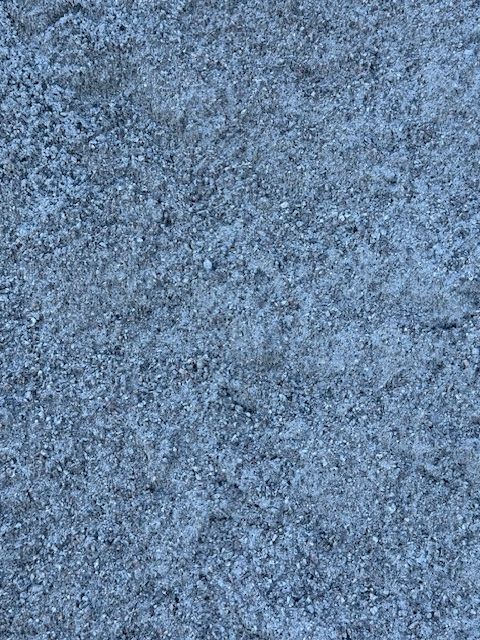 Textured gray asphalt surface with small stones.
