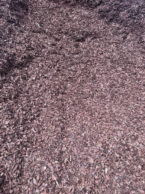 Pile of dark brown mulch.