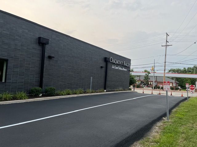 A dark gray brick building labeled 