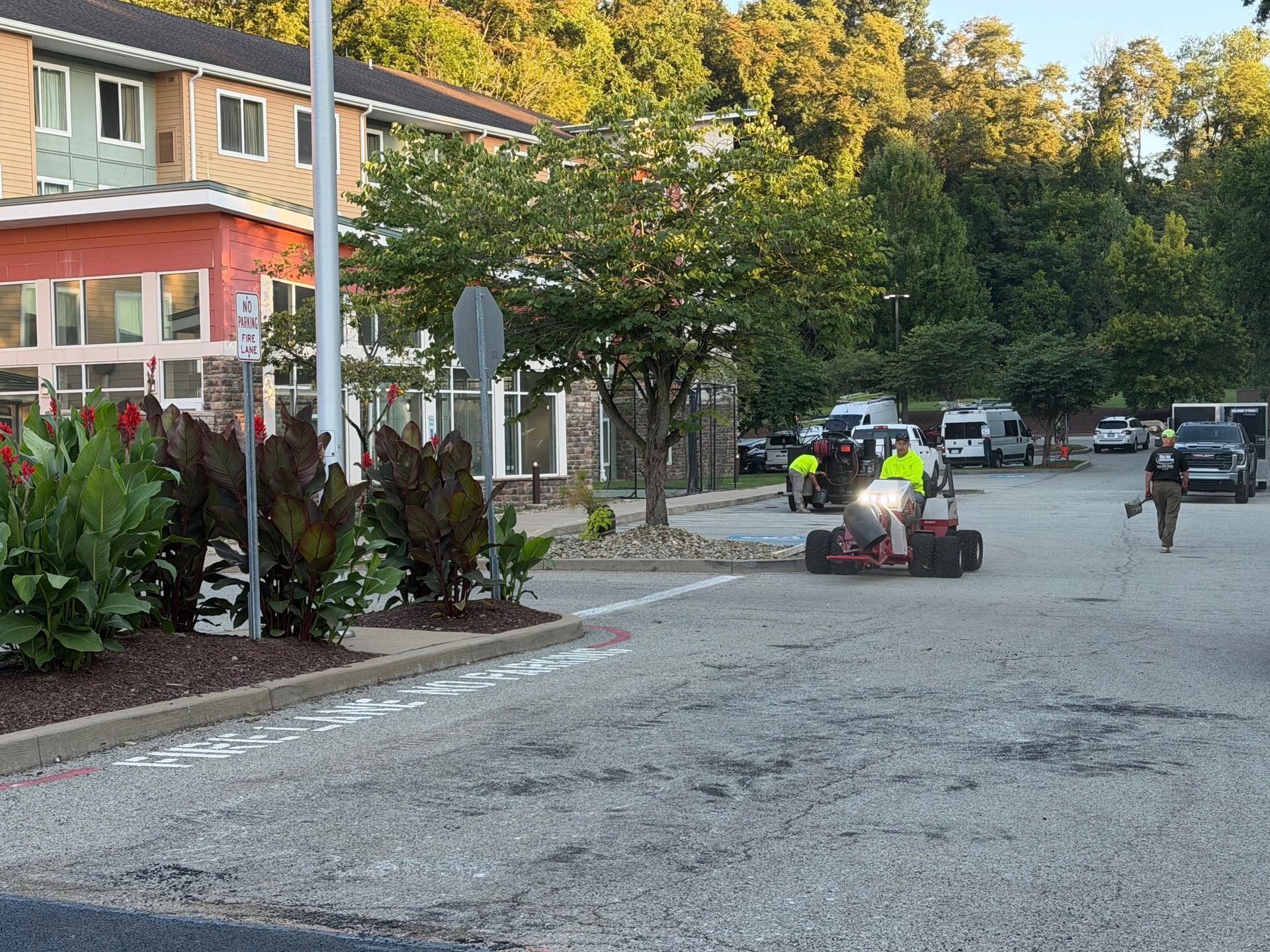 Street scene with two go-karts on a road beside houses and trees, one driver in a neon yellow shirt