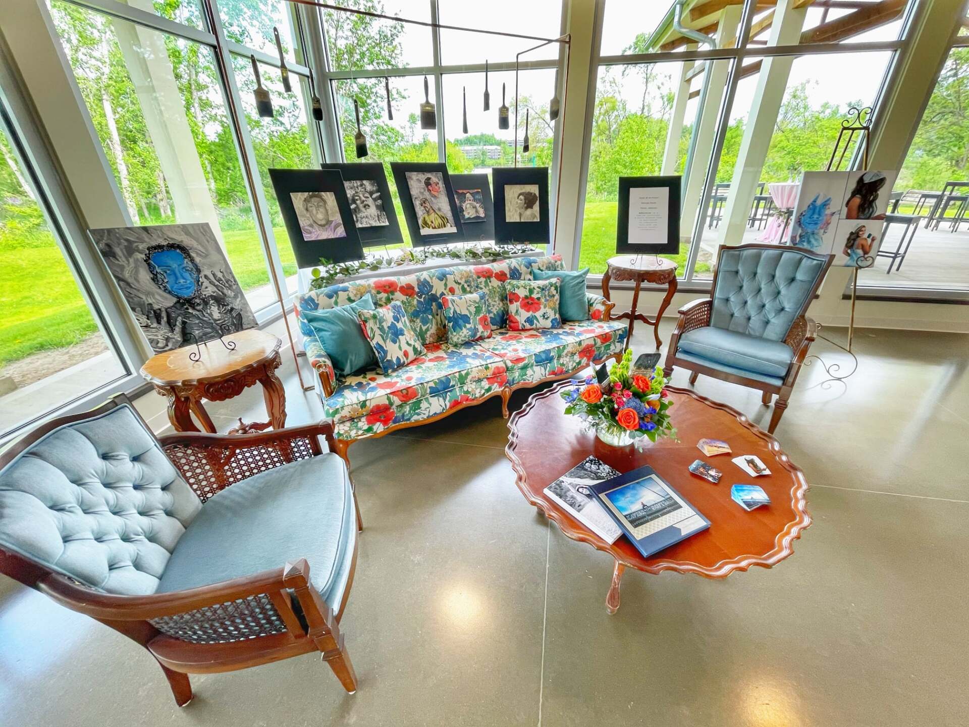 A living room with a couch , chairs , and a coffee table.