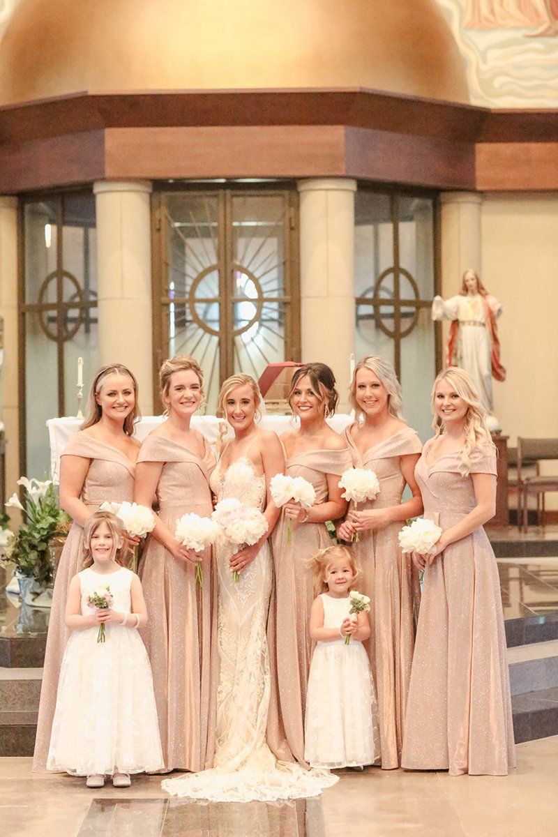 A bride with her bridesmaid and flower girls