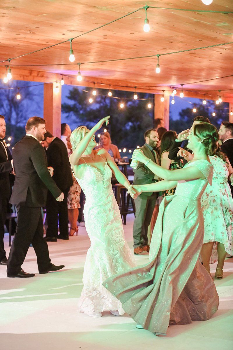 A bride dancing with her friends