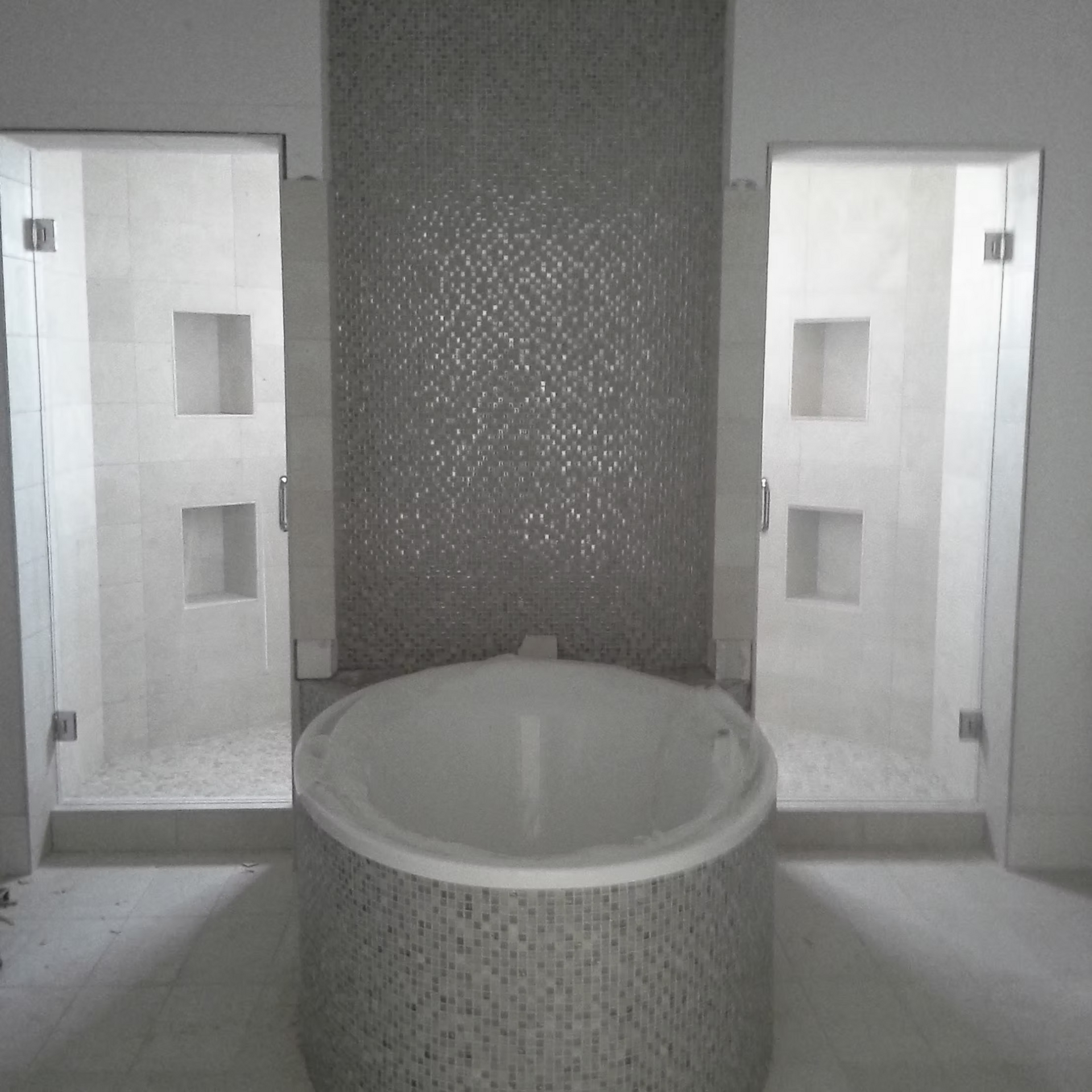 There is a bathtub in the middle of the bathroom.