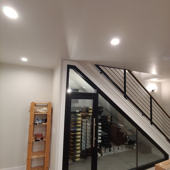 A room with a staircase and a glass door