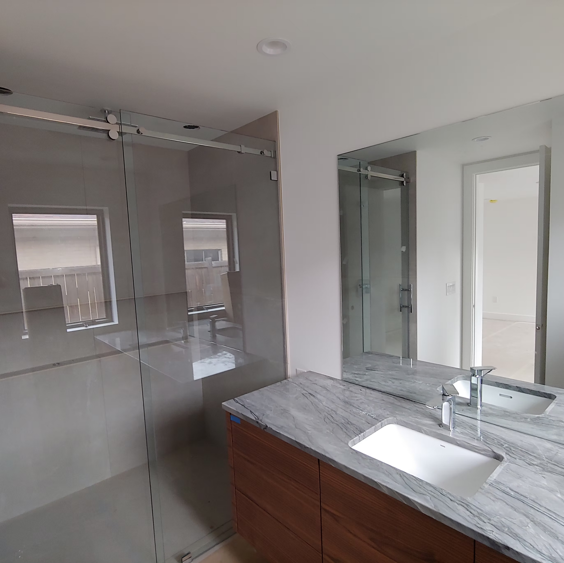 A bathroom with a sink and a large mirror