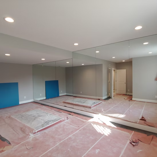 A large room with a lot of mirrors on the wall.