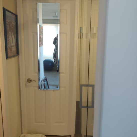A door with a mirror on it in a hallway