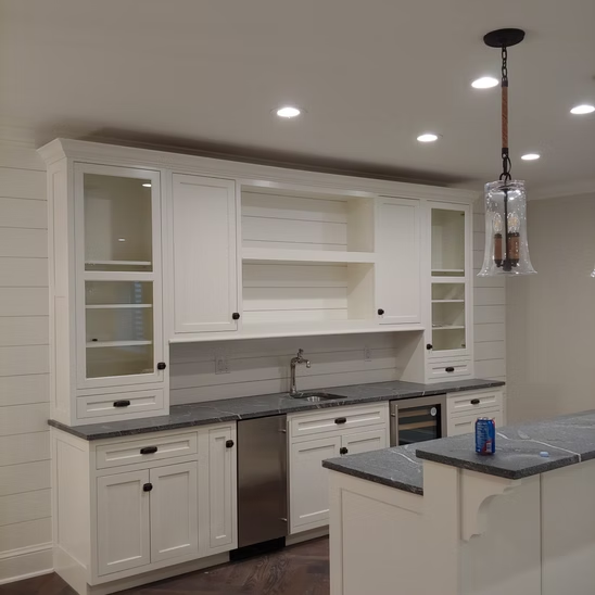 A kitchen with white cabinets and stainless steel appliances