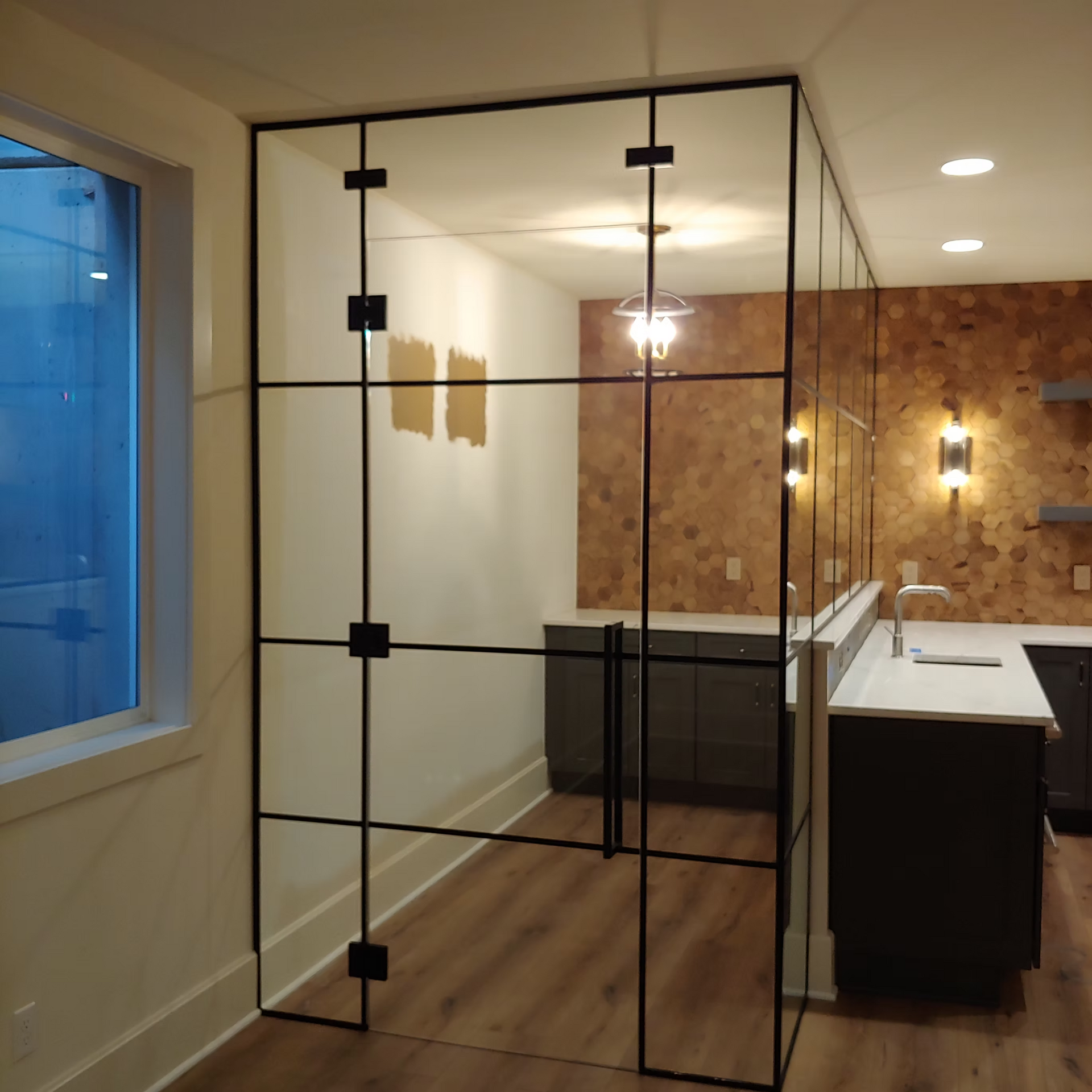 A room with a glass wall and a window