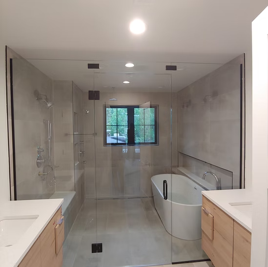 A bathroom with a bathtub , sink , and shower.