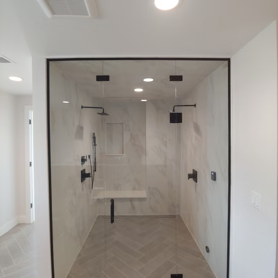 A bathroom with a walk in shower and a bench