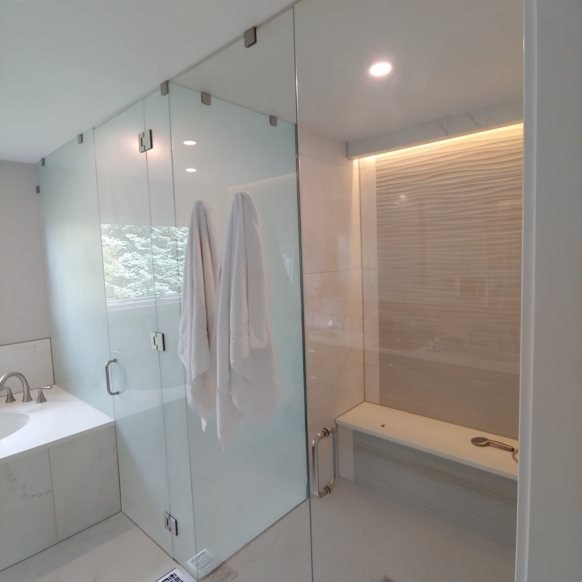 A bathroom with a walk in shower and a bathtub.