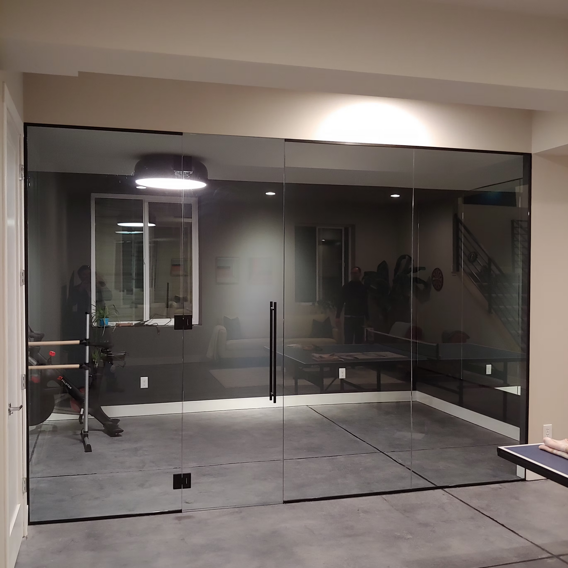 A room with a lot of glass doors and a bench