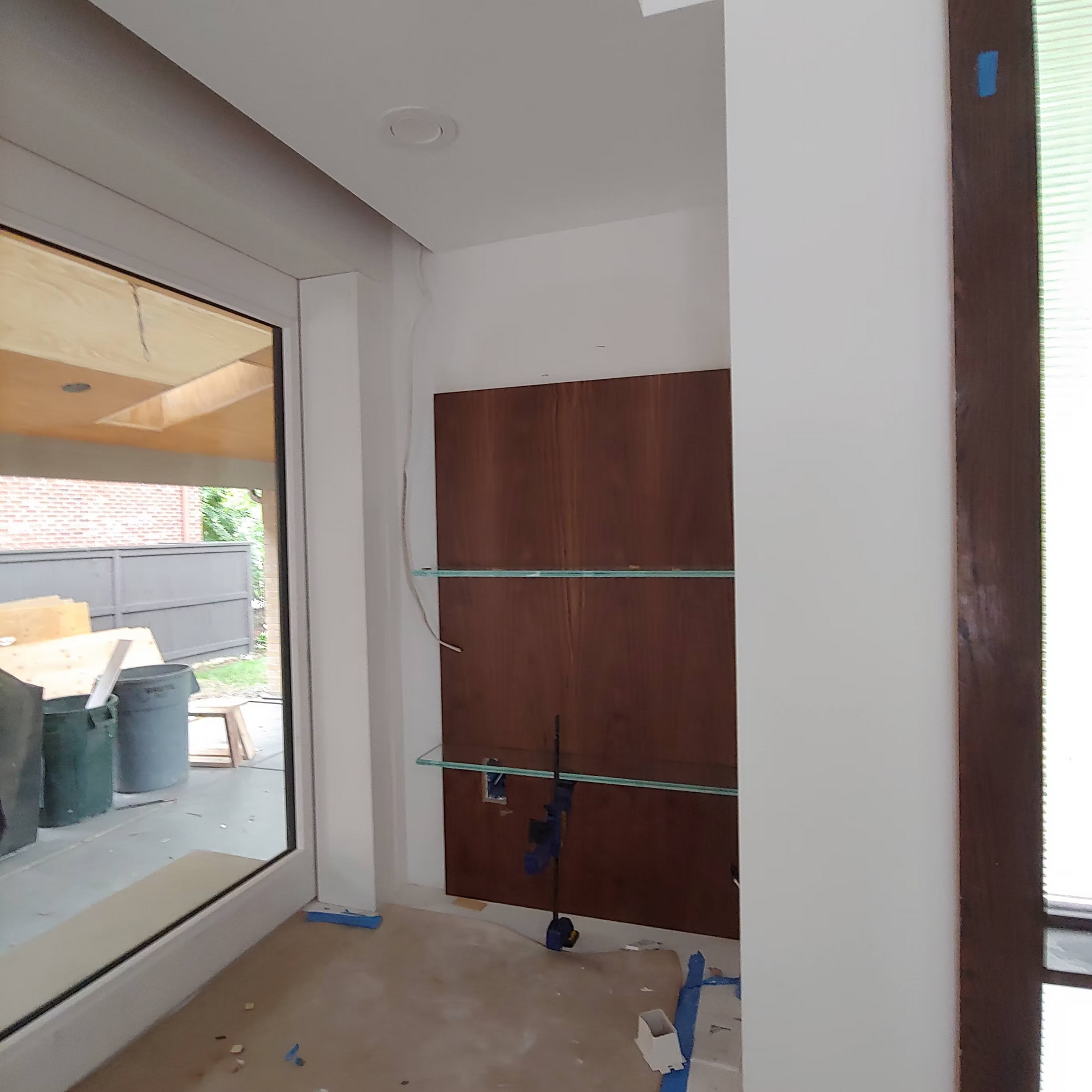 A room with a large window and a wooden door