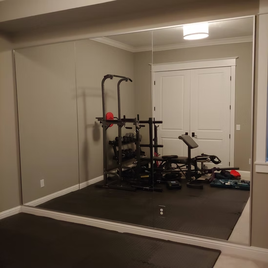 A gym with a large mirror on the wall
