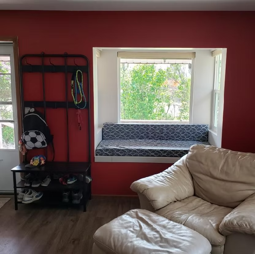 A living room with a couch and a window seat