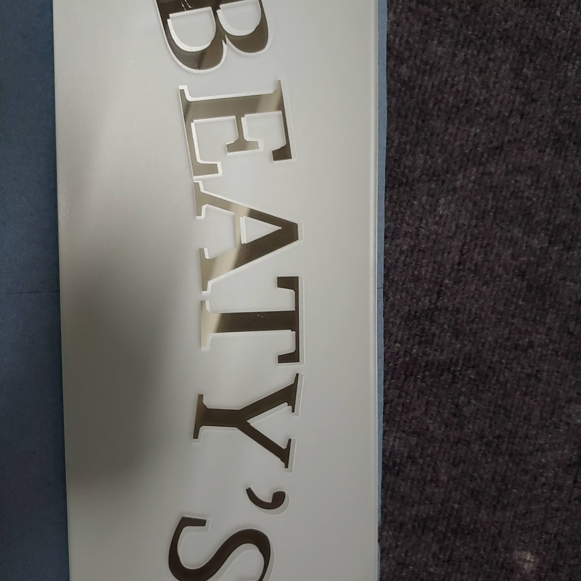 A white sign that says beaty 's on it