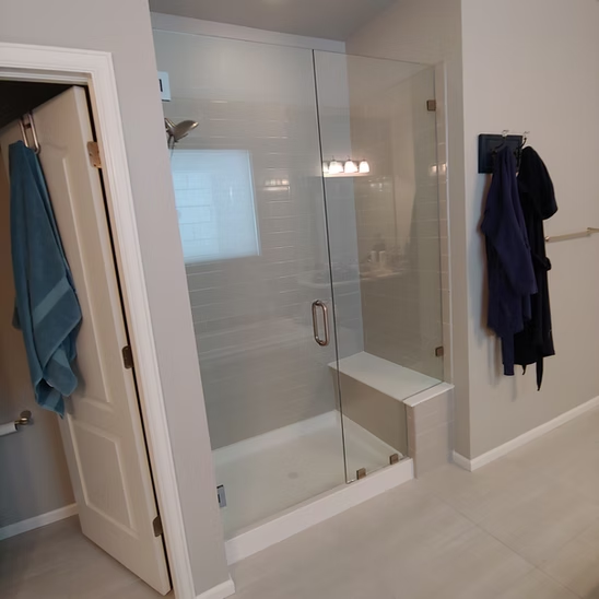 A bathroom with a walk in shower and a bathtub