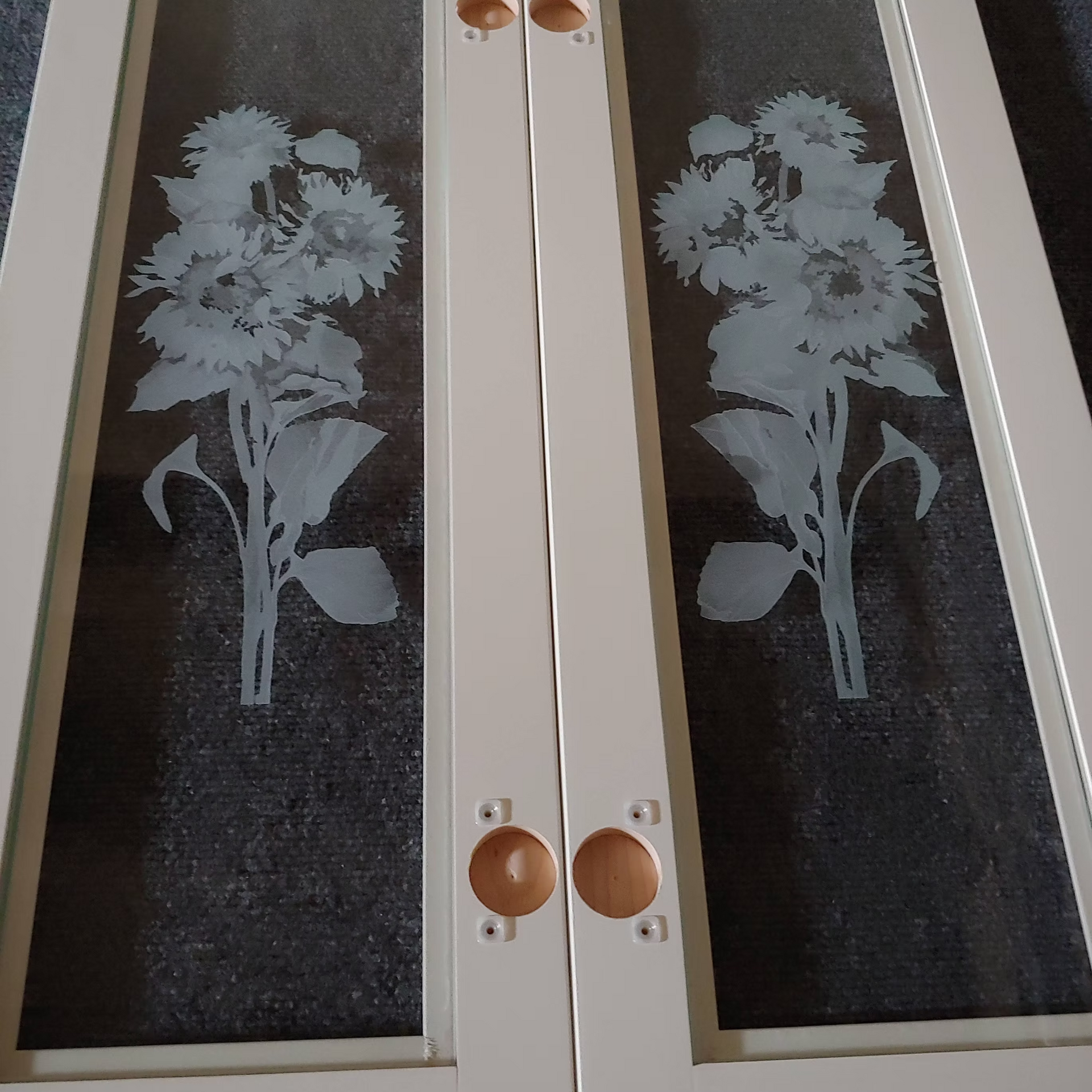 A pair of doors with flowers etched on them