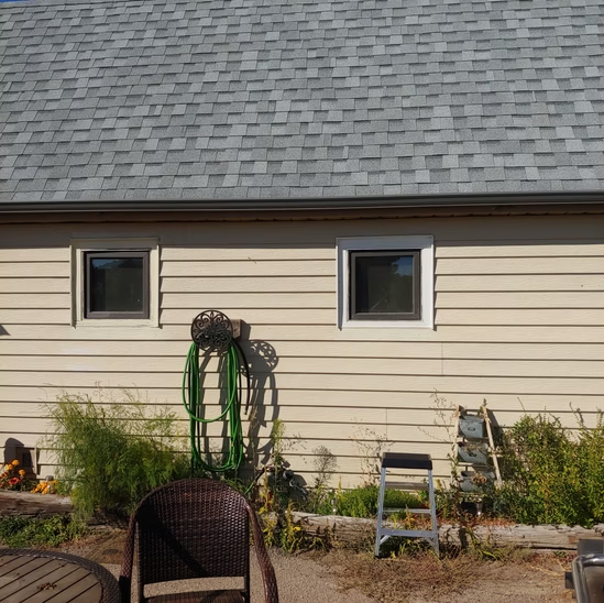 A house with a hose attached to the side of it