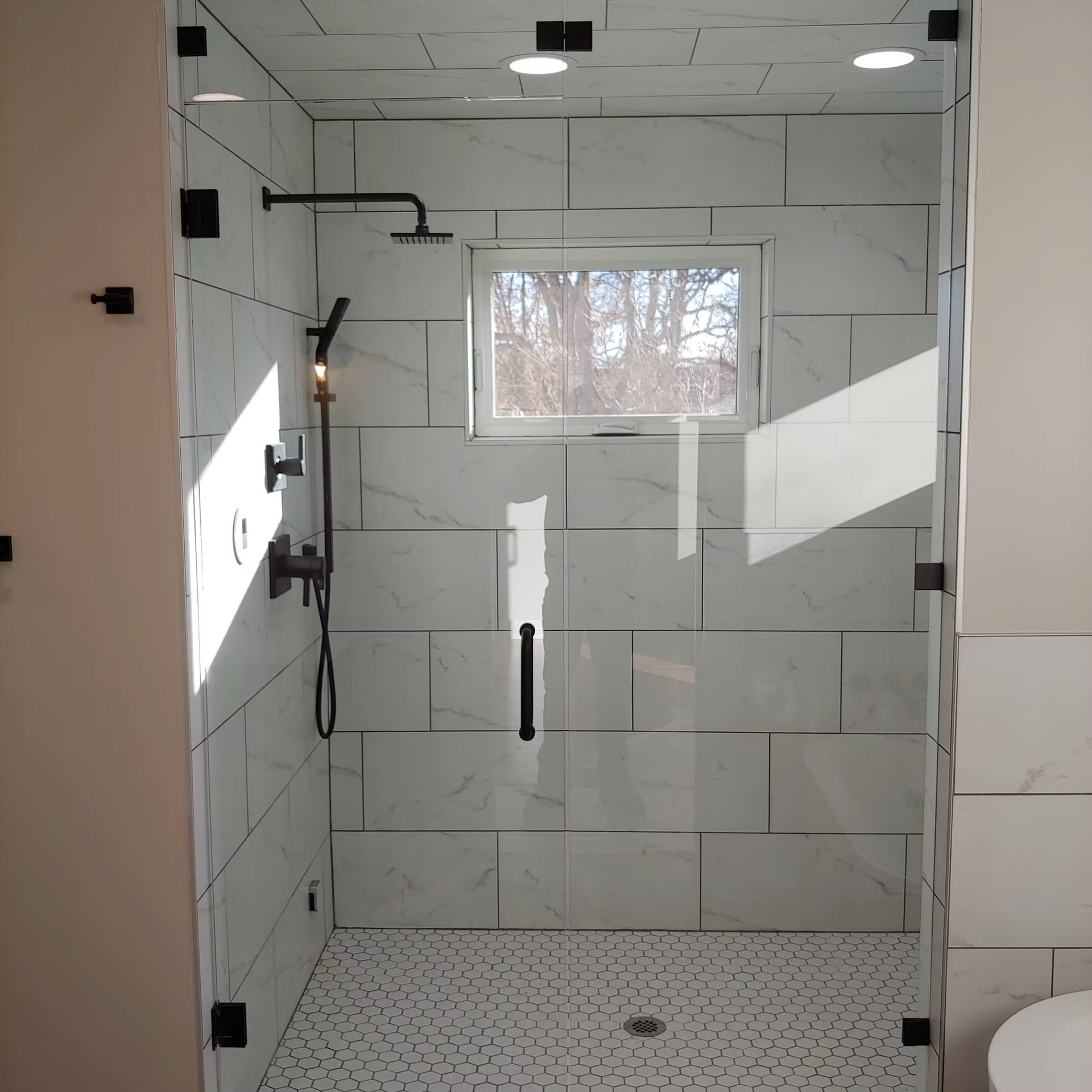A bathroom with a walk in shower and a toilet
