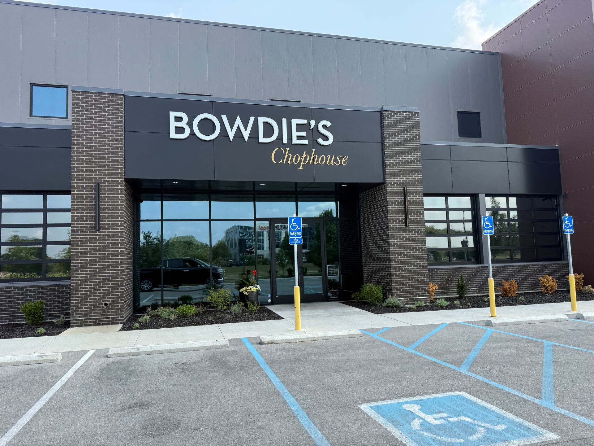 Bowdie’s Chophouse storefront with dark exterior and accessible parking spaces in front