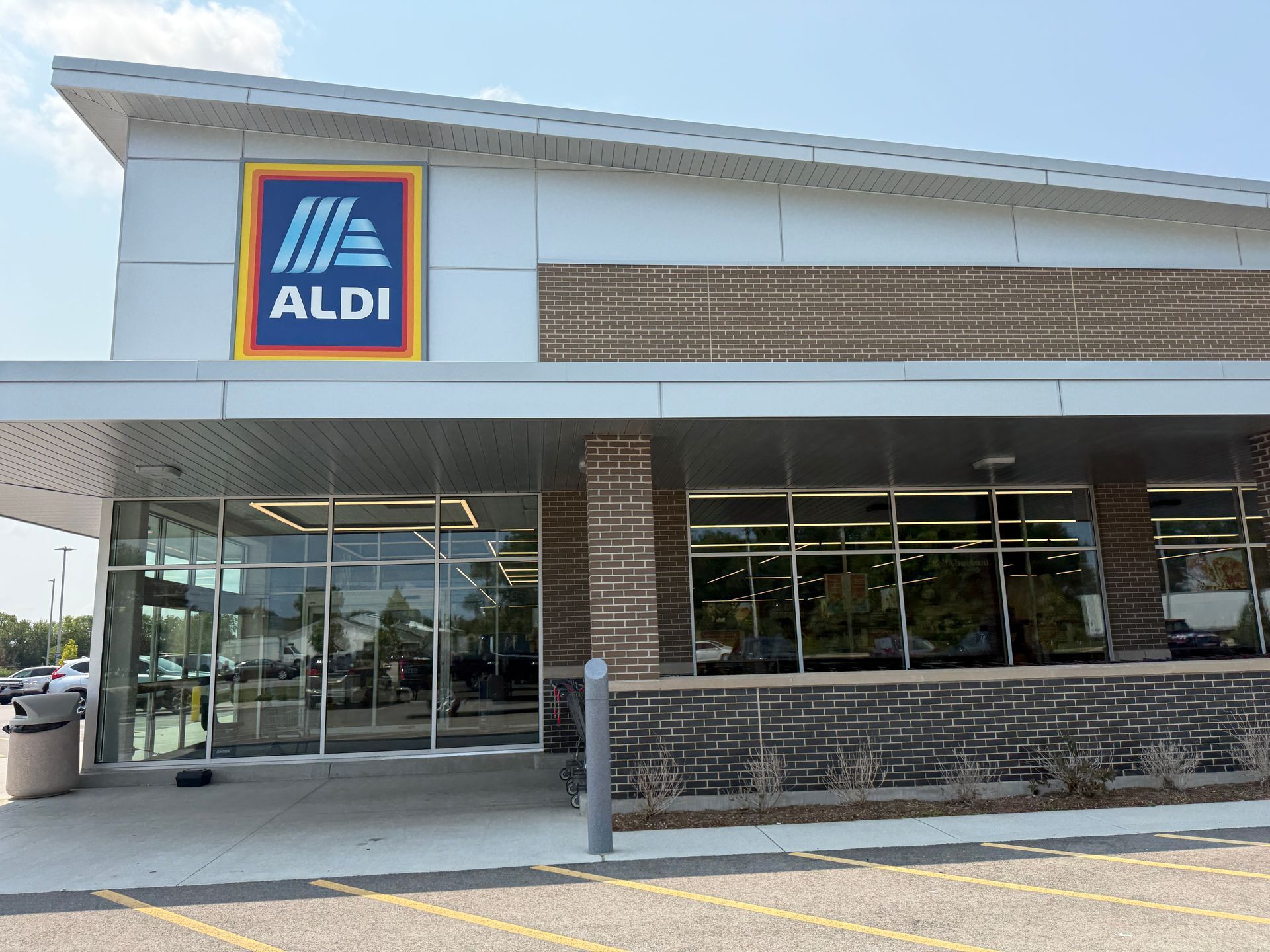 ALDI grocery store exterior with glass entrance and brick facade