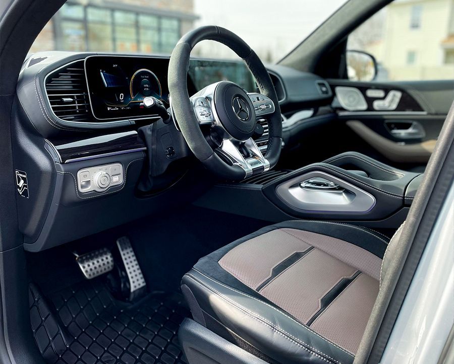 the interior of a car with a steering wheel and seats