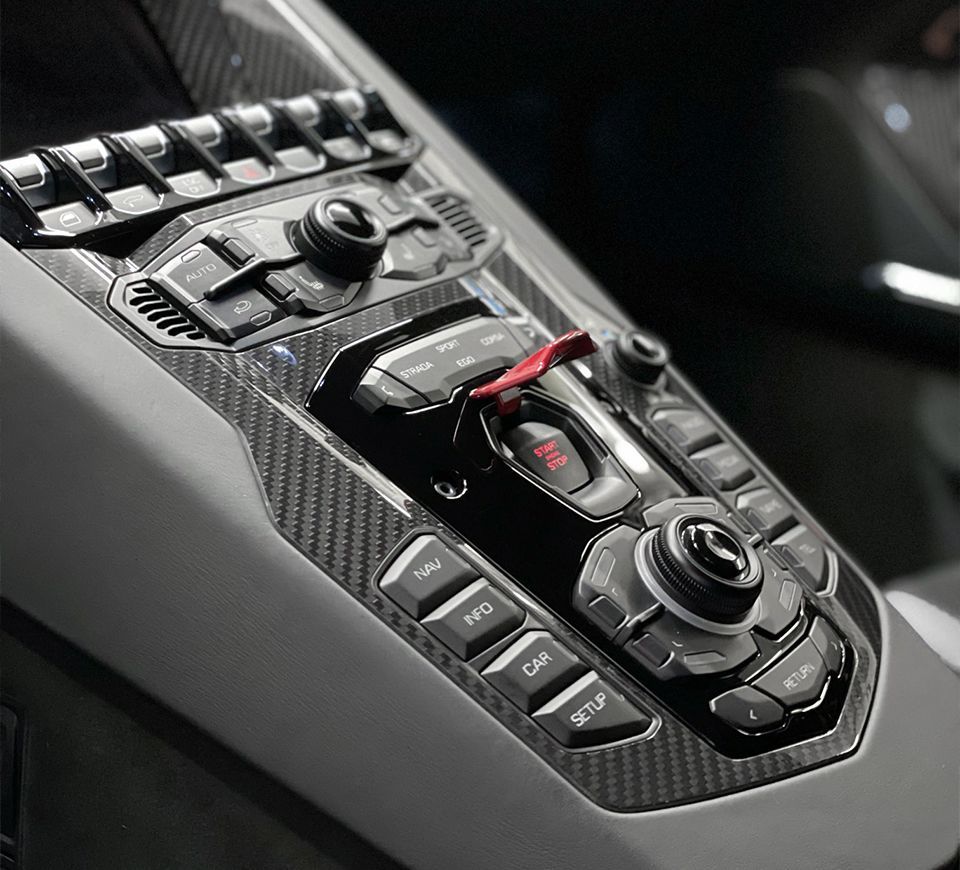 a close up of a car dashboard with a red button that says emergency stop