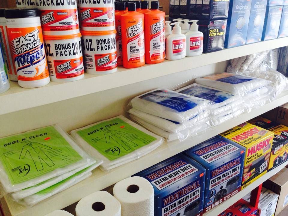 A shelf full of cleaning products including husky wipes
