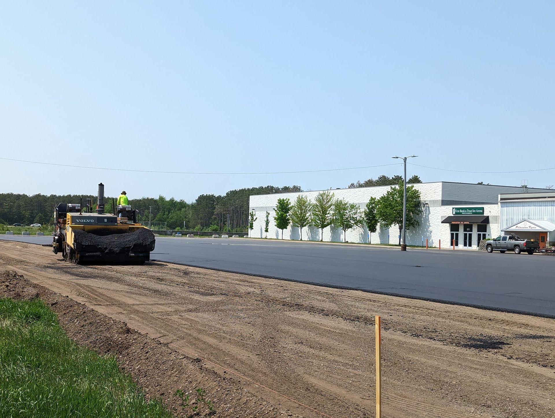 A road is being paved in front of a building.