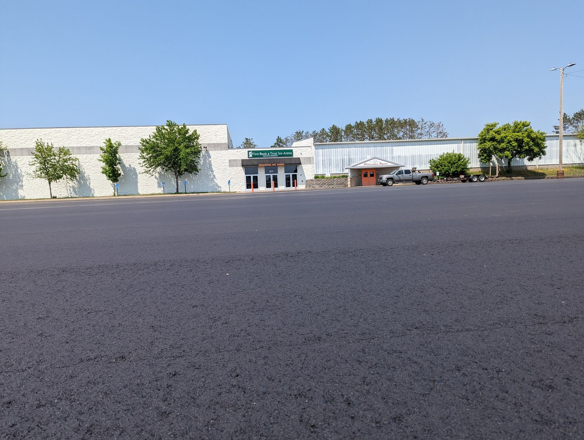 A parking lot with a building in the background