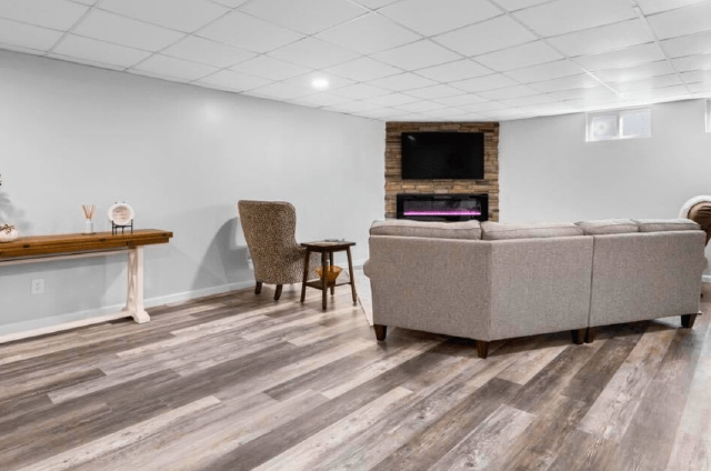 A living room with a couch, chairs, and a fireplace.